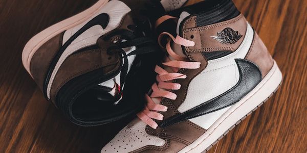 A pair of athletic shoes on a clean wooden floor.