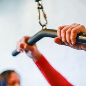Close-up of a person's hands gripping the floor during a workout.